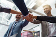 © Kostiantyn - Happy group of business coworkers stacked hands together as concept of corporate unity