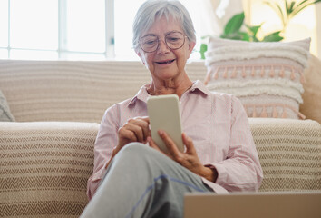 Sticker - Senior woman sitting on the floor at home while reading a message on mobile phone, elderly lady enjoying technology and communication