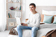 © Pixel-Shot - Teenage boy using laptop in bedroom