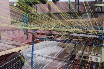 colored linen warp threads on a weaving machine