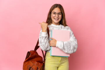 Wall Mural - Student little girl over isolated pink background pointing to the side to present a product