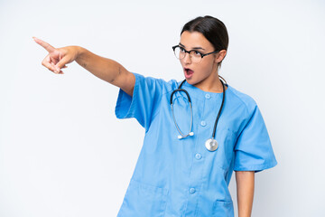 Sticker - Young nurse woman isolated on white background pointing away