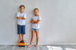 © Inna Vlasova - Cool kids, little boy and girl measure their height a