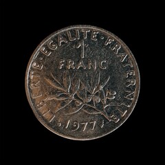 Wall Mural - Closeup of a 1 franc coin from 1977 on a black background, the former French national currency