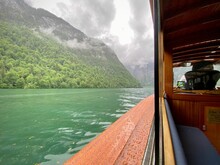 Boat Ride Over Lake Konigssee In Bayern Germany With Hills With Forest And Clouds Above