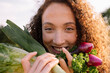 © Westend61 - Smiling woman holding fresh organic vegetables