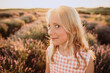 © Westend61 - Girl with blond hair making facial expression in lavender field on sunset
