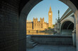 Houses of Parliament at dawn framed by arch