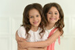 © aletia2011 - Studio portrait of cute twin sisters posing