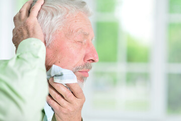 Sticker - Portrait of sad sick senior man at home