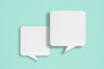 two blank white speech bubble paper cut, on grunge blue paper background. conceptual image about com