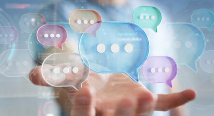 Businessman using digital speech bubbles talk icons. Minimal conversation or social media messages floating over user hand. 3D rendering