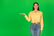 © Prostock-studio - Happy Lady Holding Invisible Object On Hand Over Green Background