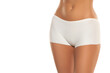 © vladimirfloyd - Mid section of woman wearing white briefs,  front view on a white background.