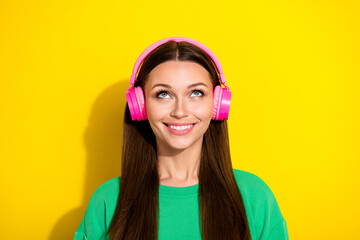 Poster - Photo of cheerful pretty girl beaming smile look interested up empty space isolated on yellow color background