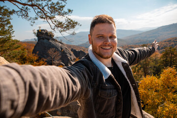 Poster - man hiker taking selfie on the top of dovbush rocks Ukraine