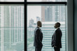 © ReeldealHD images - White collar African American businessmen looking at view of city skyline