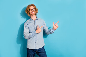 Poster - Portrait of positive satisfied person look interested direct fingers empty space blank isolated on blue color background