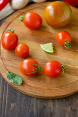 Canvas Print - Few Cherry tomatoes on a wooden board