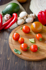 Canvas Print - Few Cherry tomatoes on a wooden board