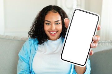 Wall Mural - Cheerful African American Lady Showing Big Cellphone Blank Screen Indoors