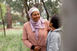 © Austockphoto - Close up shot of a middle aged woman wearing pink hijab talking to a boy with curly hair and glasses