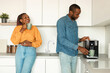 © Prostock-studio - Happy african american couple preparing fresh aromatic coffee with machine in kitchen, enjoying hot morning beverage