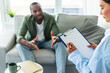 © Prostock-studio - Psychological assistance. African american man having counseling session with therapist at office