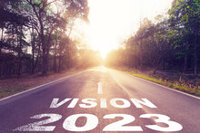 Empty Asphalt Road And New Year 2023 Concept. Driving On An Empty Road To Vision 2023 With Sunset.