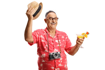 Wall Mural - Mature male tourist holding a cocktail and greeting with hat