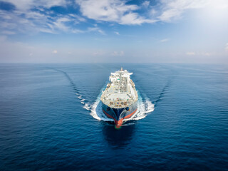 Wall Mural - Front view of a large LNG or liquid gas tanker vessel traveling with high speed over blue ocean