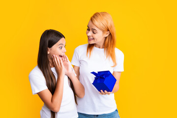 Poster - Mother gives a gift to her teen daughter, isolated background. Happy family concept. Girl with mother together. Valentine.