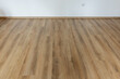 © dechevm - Laminated wood floor with white wall. Empty room with floating laminate in new apartmen
