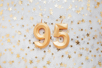 Wall Mural - Number 95 ninety five golden celebration birthday candle on Festive Background. ninety five years birthday. concept of celebrating birthday, anniversary, important date, holiday