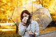 © Prostock-studio - Unhappy millennial european woman in raincoat with umbrella blows her nose in napkin, feels bad in park