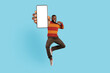 Check This. Excited Black Man Jumping And Showing Big Blank Smartphone