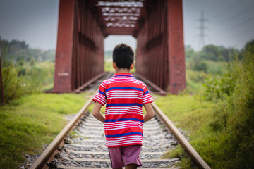 Wall Mural - A young boy on the railway