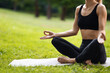 © Prostock-studio - Cropped of slim sporty woman meditating outdoors