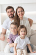 © alotofpeople - Happy family with children on sofa
