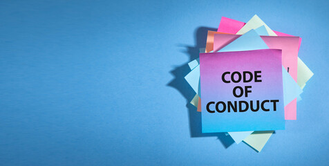 text code of conduct on sticky note.
