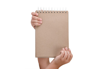 Wall Mural - Notepad isolated on white background. Brown notepad made from recycled paper on a white background in the hands of a child