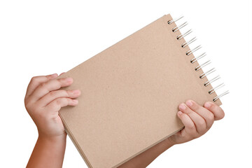 Wall Mural - Notepad isolated on white background. Brown notepad made from recycled paper on a white background in the hands of a child