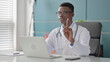© stockbakers - Young African Doctor Shaking Head as No Sign while using Laptop in Office