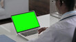 © stockbakers - Young African Doctor Using Laptop with Green Screen