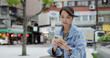 © leungchopan - Woman read on mobile phone in city at outdoor