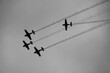 Black and white concept photo for an aerobatic show against a cloudy sky. Extreme aviation industry.