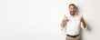Excited man in glasses showing thumbs up and looking amazed, agree and approve something great, recommending product, standing over white background