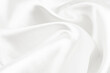© Gudman - A twisted piece of white fabric. White material or texture with waves and folds. Wrinkled white fabric
