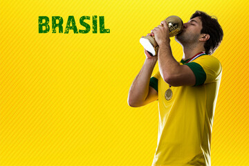 Wall Mural - brazilian player, man celebrating on a yellow background