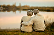 © aletia2011 - Happy senior couple sitting in summer near lake during sunset